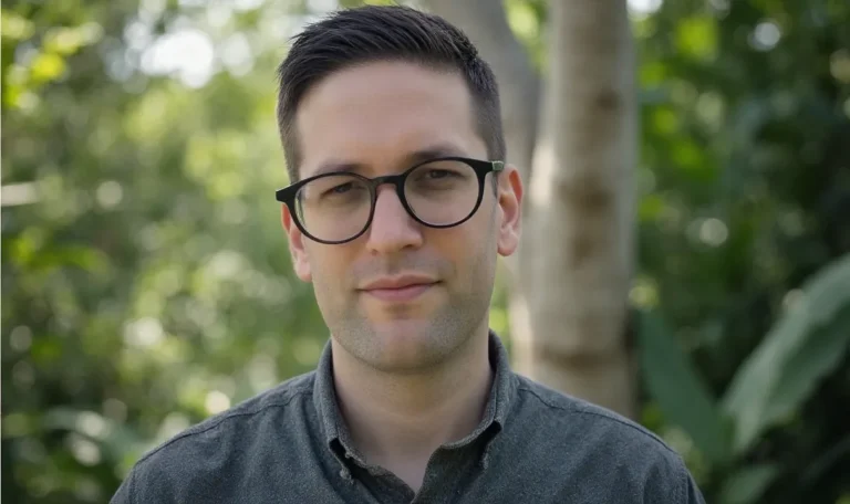 Errin wearing glasses in a forest setting