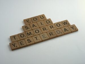 brown wooden blocks on white table - Is Procrastination a Sign of ADHD