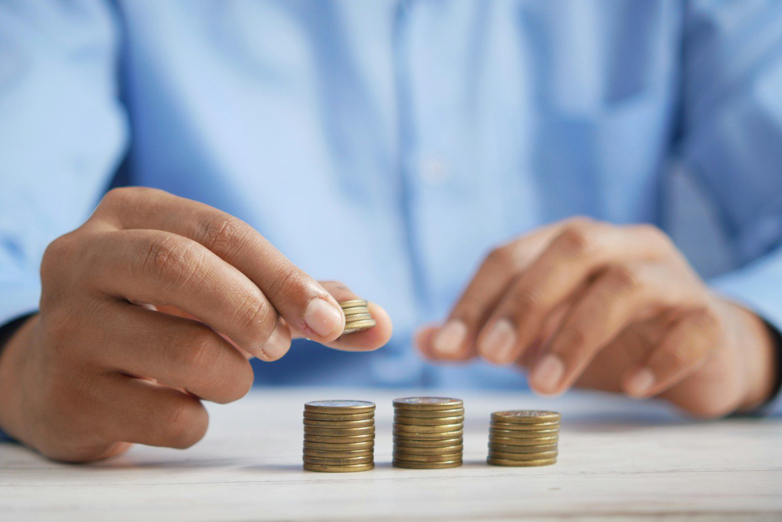 a person stacking coins on top of a table Xero tracking for external funding