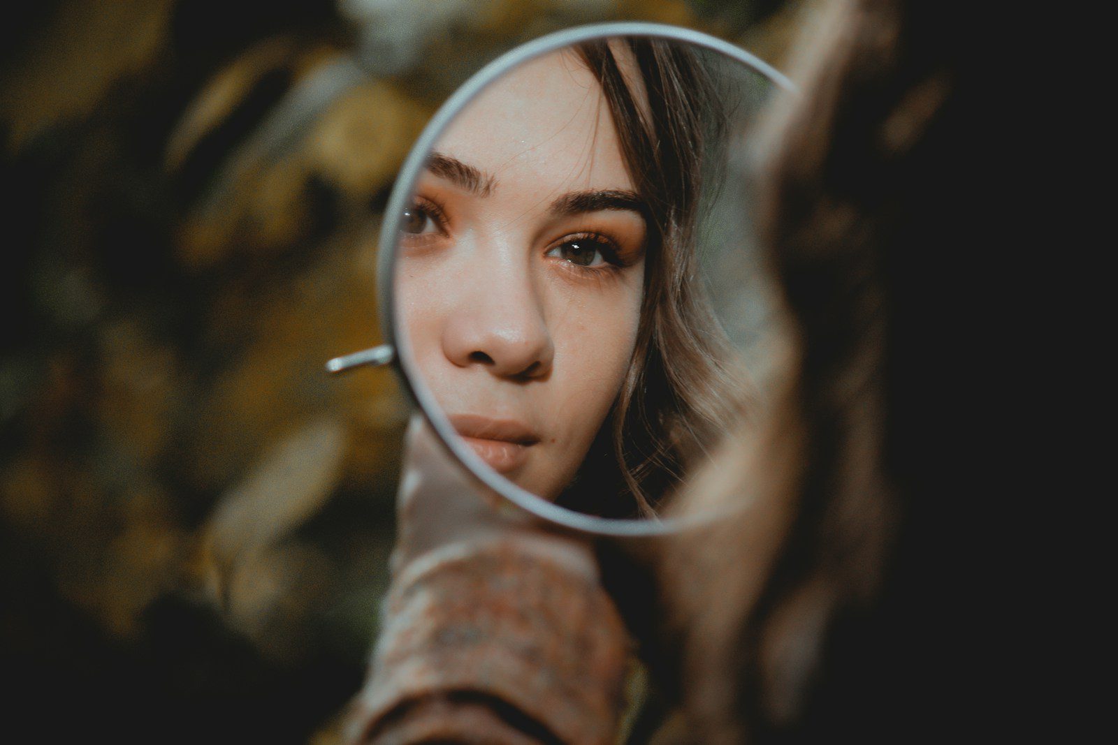 woman holding magnifying glass with brown liquid ADHD and narcissism