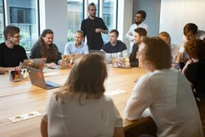 a group of people sitting around a wooden table adhd business coaching