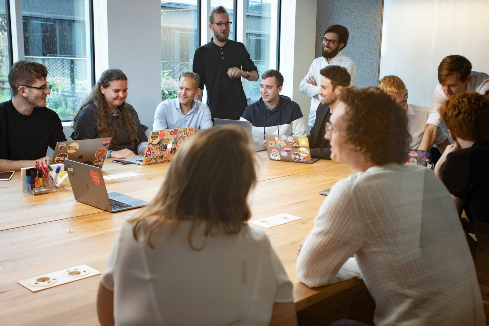 a group of people sitting around a wooden table adhd business coaching