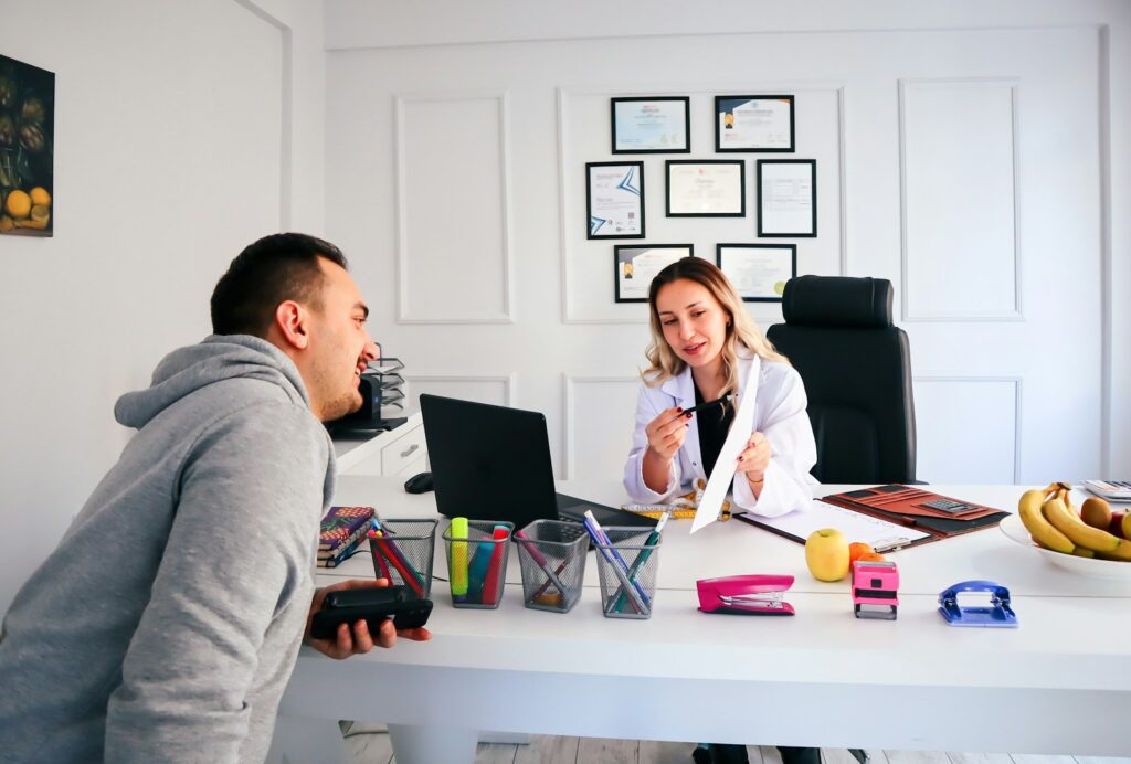 a man and a woman sitting at a table - adhd workplace coaching